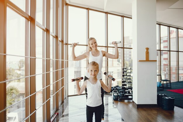 Mother with daughter in a gym