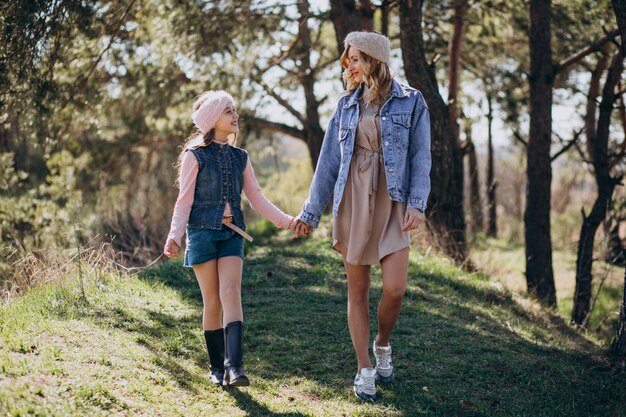 Mother with daughter having fun in the forest