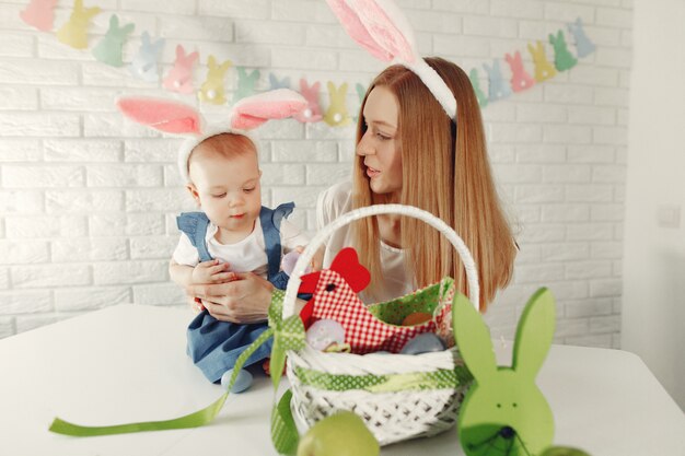 Mother with daughter in a kitchen preparing to easter