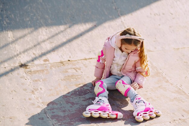 Mother with daughter in a park with rollers