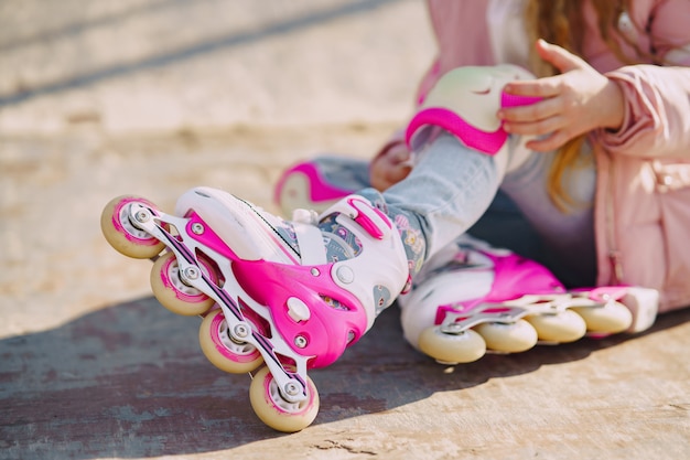 Mother with daughter in a park with rollers