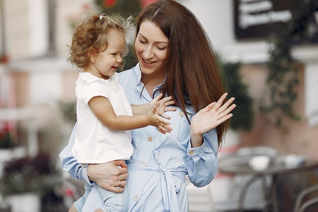 Mother with daughter playing in a summer city