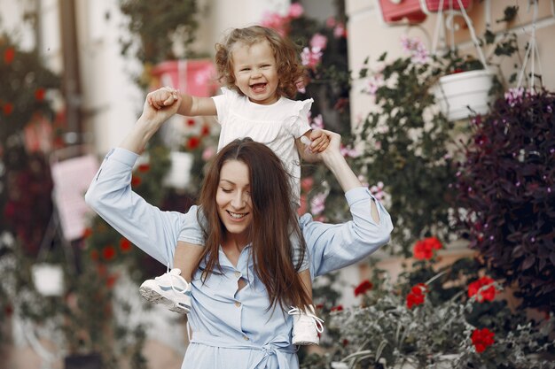 Mother with daughter playing in a summer city