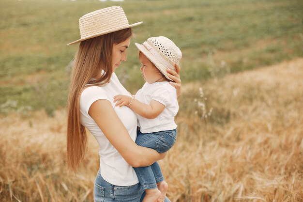 Mother with daughter playing in a summer field