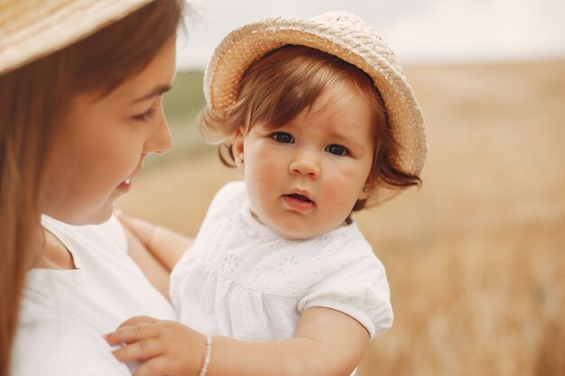 Mother with daughter playing in a summer field