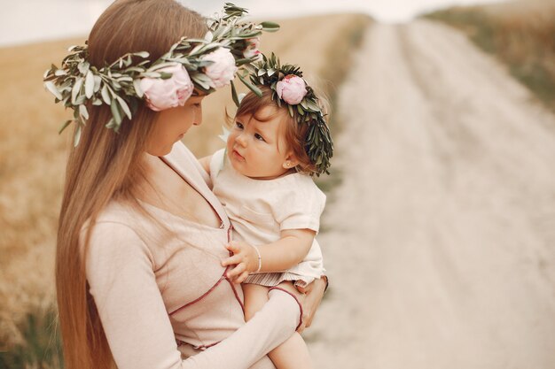 Mother with daughter playing in a summer field