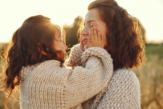 Mother with daughter playing in a summer field