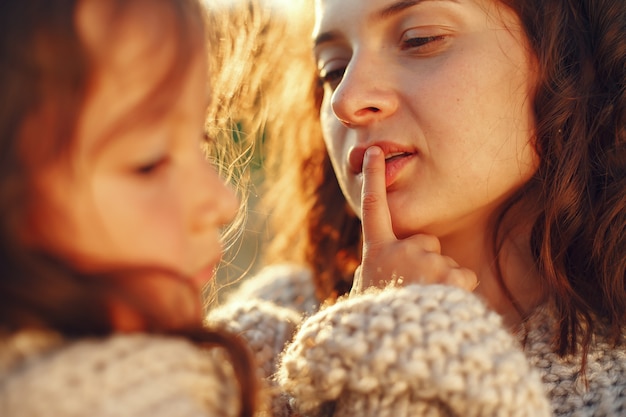 Free photo mother with daughter playing in a summer field