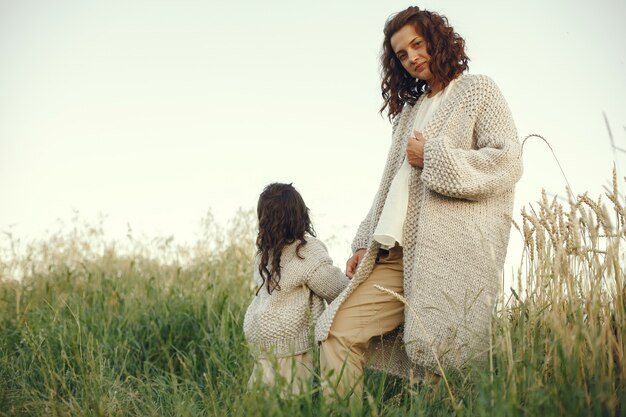 Mother with daughter playing in a summer field