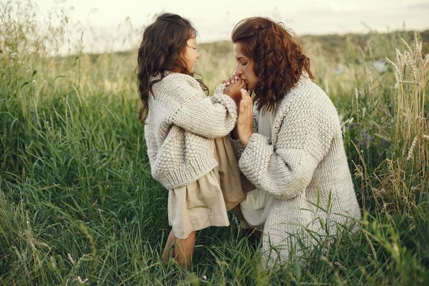 Mother with daughter playing in a summer field