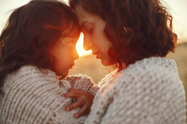 Free photo mother with daughter playing in a summer field