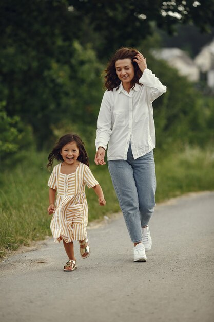 Mother with daughter playing in a summer field