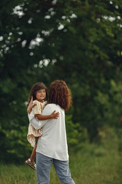 Mother with daughter playing in a summer field