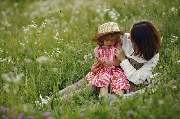 Mother with daughter playing in a summer field