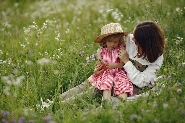 Mother with daughter playing in a summer field