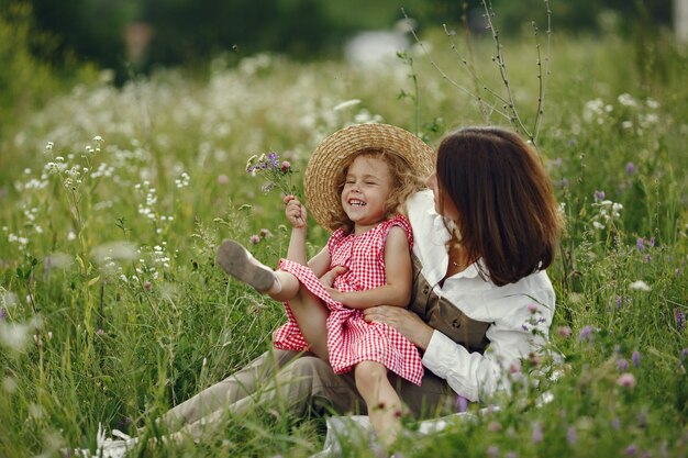 Mother with daughter playing in a summer field