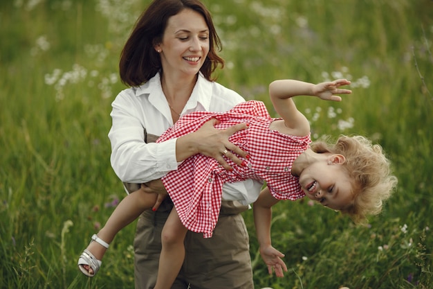 Mother with daughter playing in a summer field