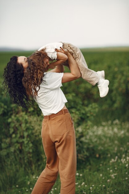 Mother with daughter playing in a summer field