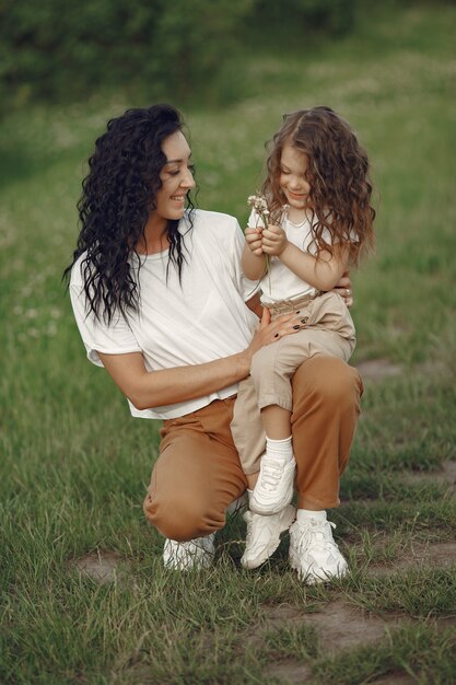 Mother with daughter playing in a summer field