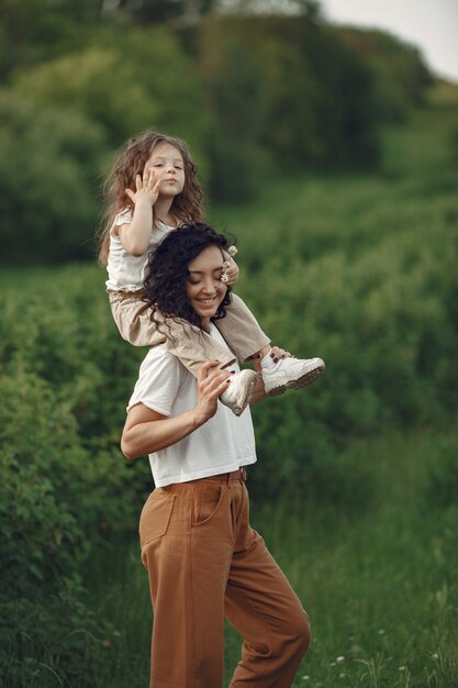 Mother with daughter playing in a summer field