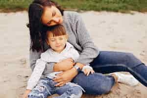 Free photo mother with daughter playing in a summer park