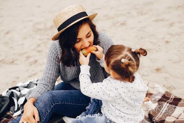 Mother with daughter playing in a summer park