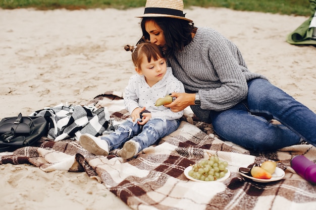 Mother with daughter playing in a summer park