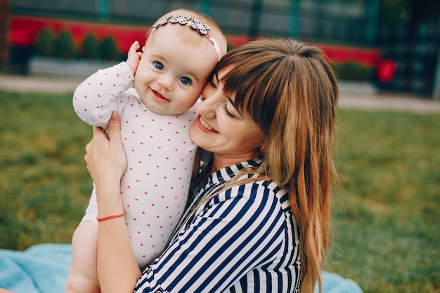 Mother with daughter playing in a summer park