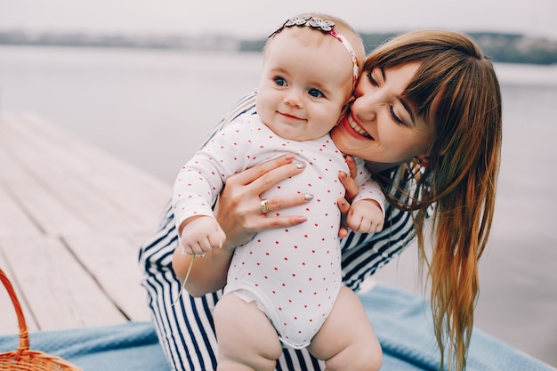 Mother with daughter playing in a summer park