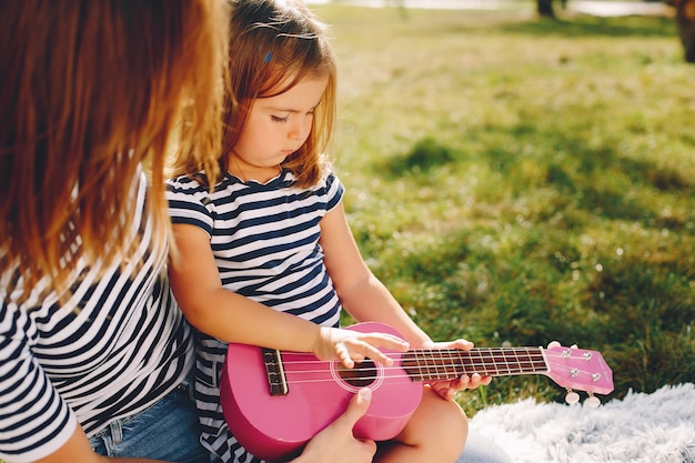 Mother with daughter playing in a summer park