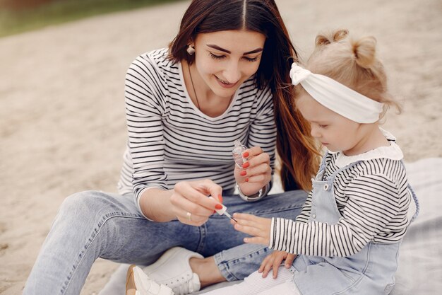 Mother with daughter playing in a summer park