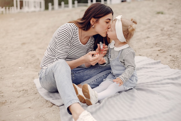 Mother with daughter playing in a summer park