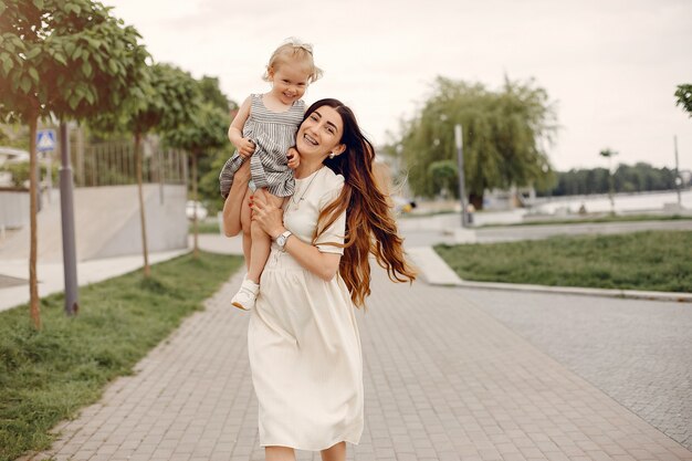 Mother with daughter playing in a summer park