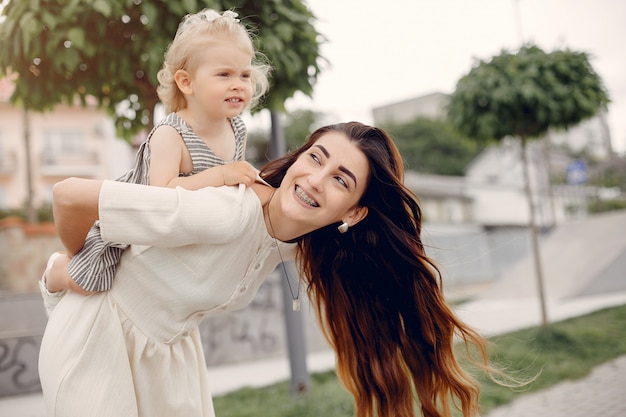 Mother with daughter playing in a summer park