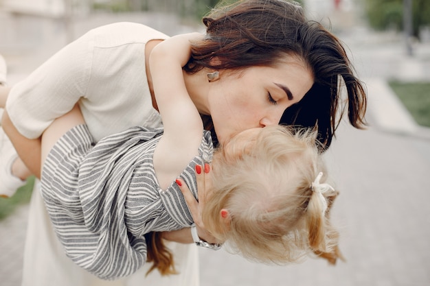 Free photo mother with daughter playing in a summer park