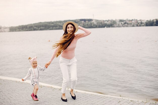 Free photo mother with daughter playing in a summer park