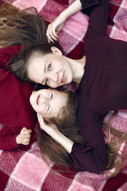 Mother with daughter playing in a summer park