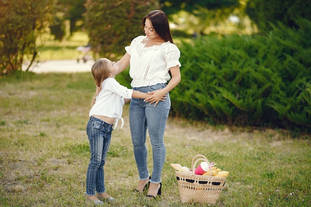 Mother with daughter playing in a summer park