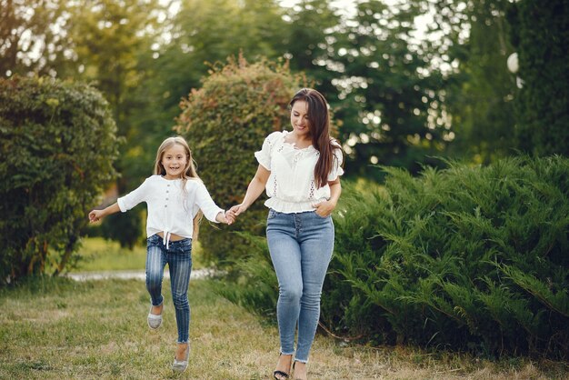 Mother with daughter playing in a summer park