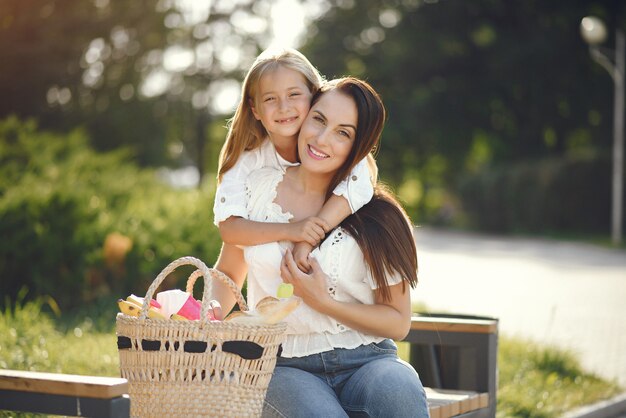 Mother with daughter playing in a summer park