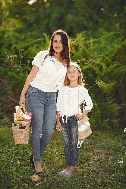 Mother with daughter playing in a summer park