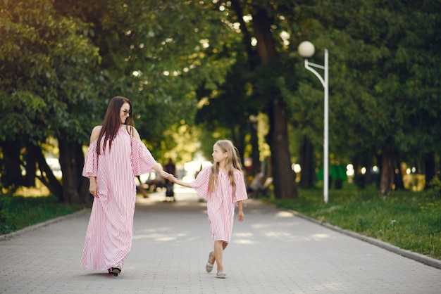 Mother with daughter playing in a summer park