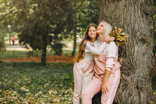 Mother with daughter playing in a summer park