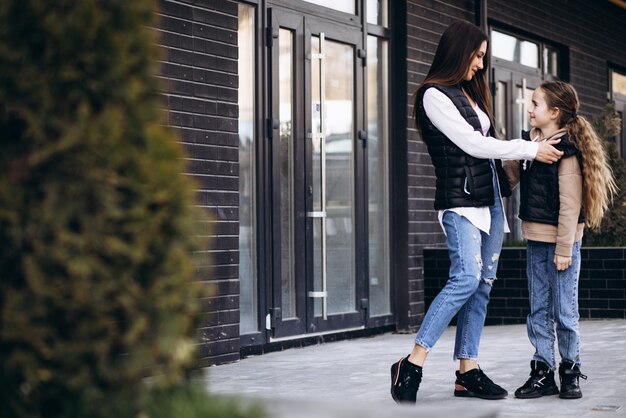 Mother with daughter posing in the street