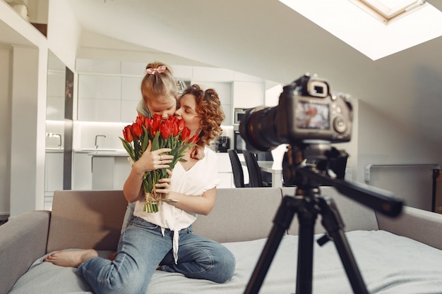 Mother with daughter shoots a blog at home