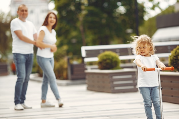 Mother with daughter in a spring park with skate