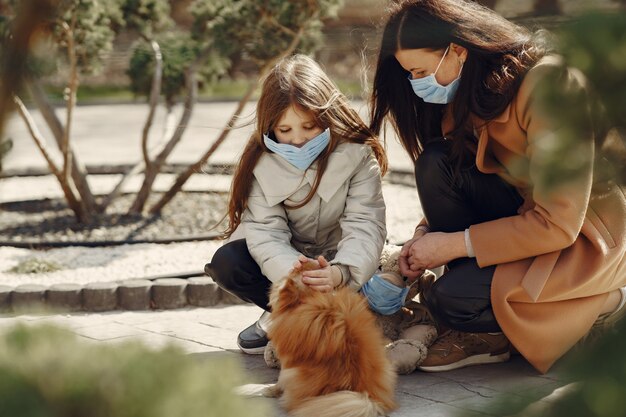 Mother with daughter walks outside in masks