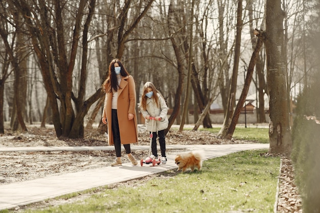 Mother with daughter walks outside in masks