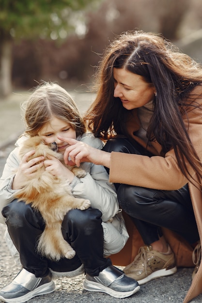 Free photo mother with daughter walks outside in masks