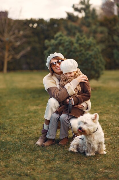 Mother with daughter walks with a dog